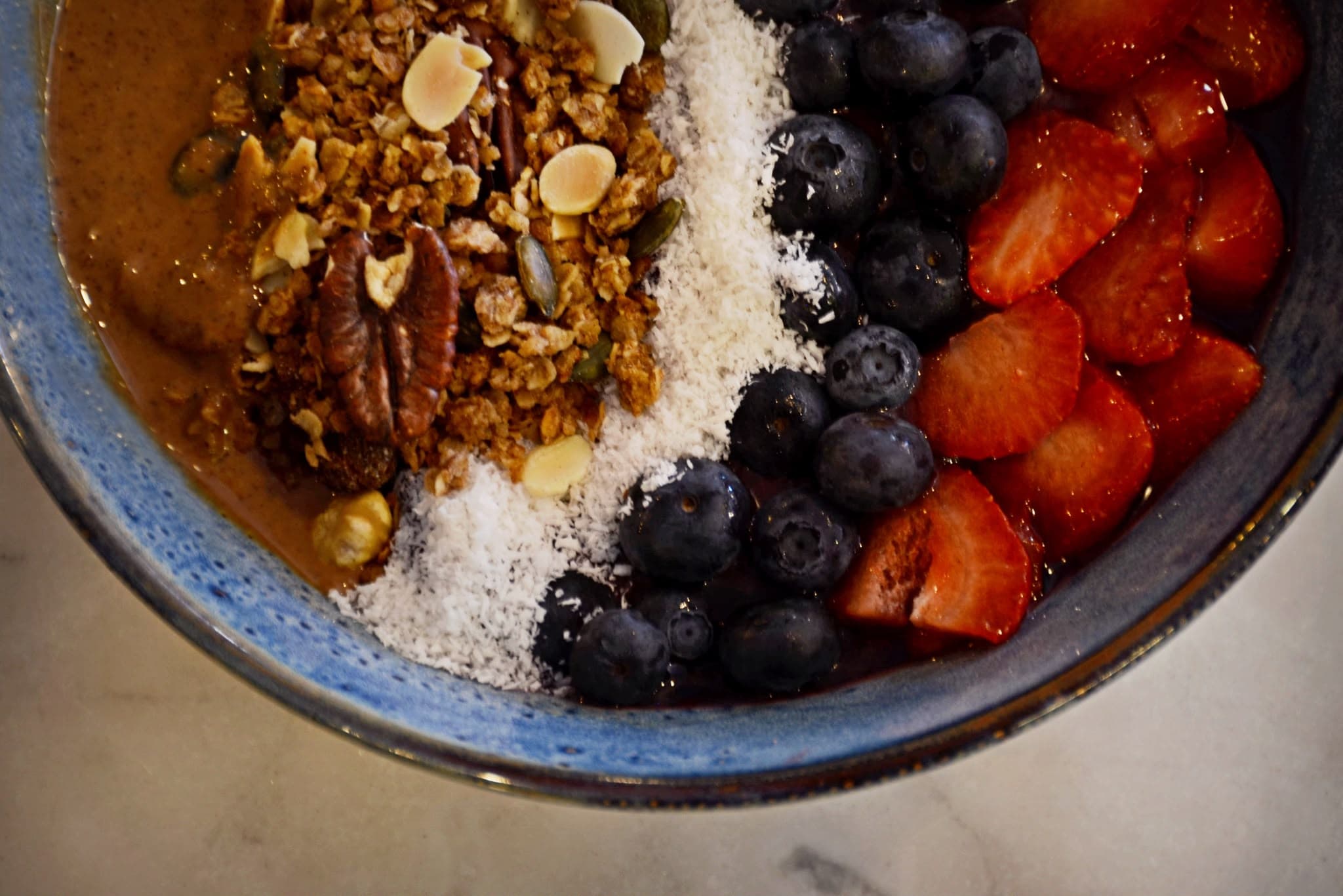 Açaí bowl topped with granola, fresh berries and coconut